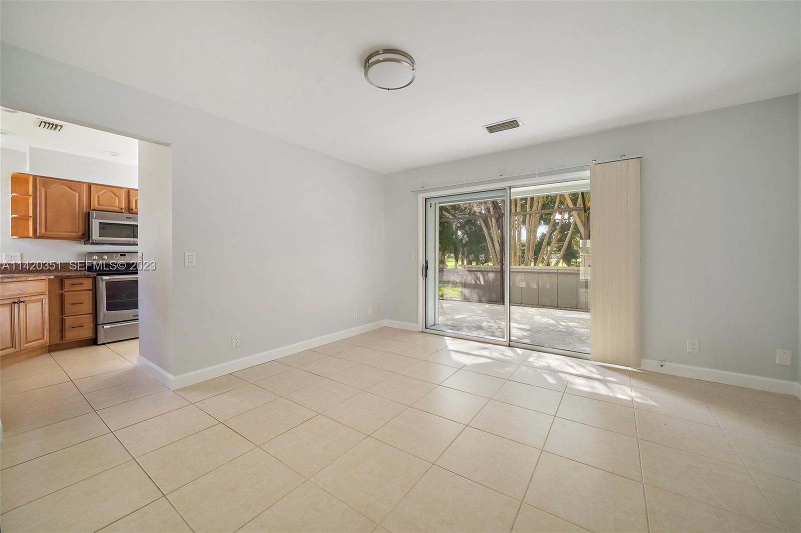 6351 Riverwalk Lane, Unit 4 Jupiter, FL 33458 - Photo 7 of 40 a view of an empty room with a window