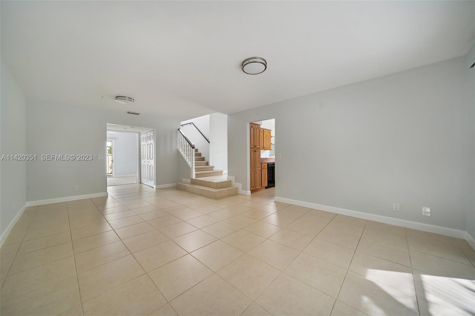 6351 Riverwalk Lane, Unit 4 Jupiter, FL 33458 - Photo 8 of 40 a view of a livingroom with wooden floor and staircase