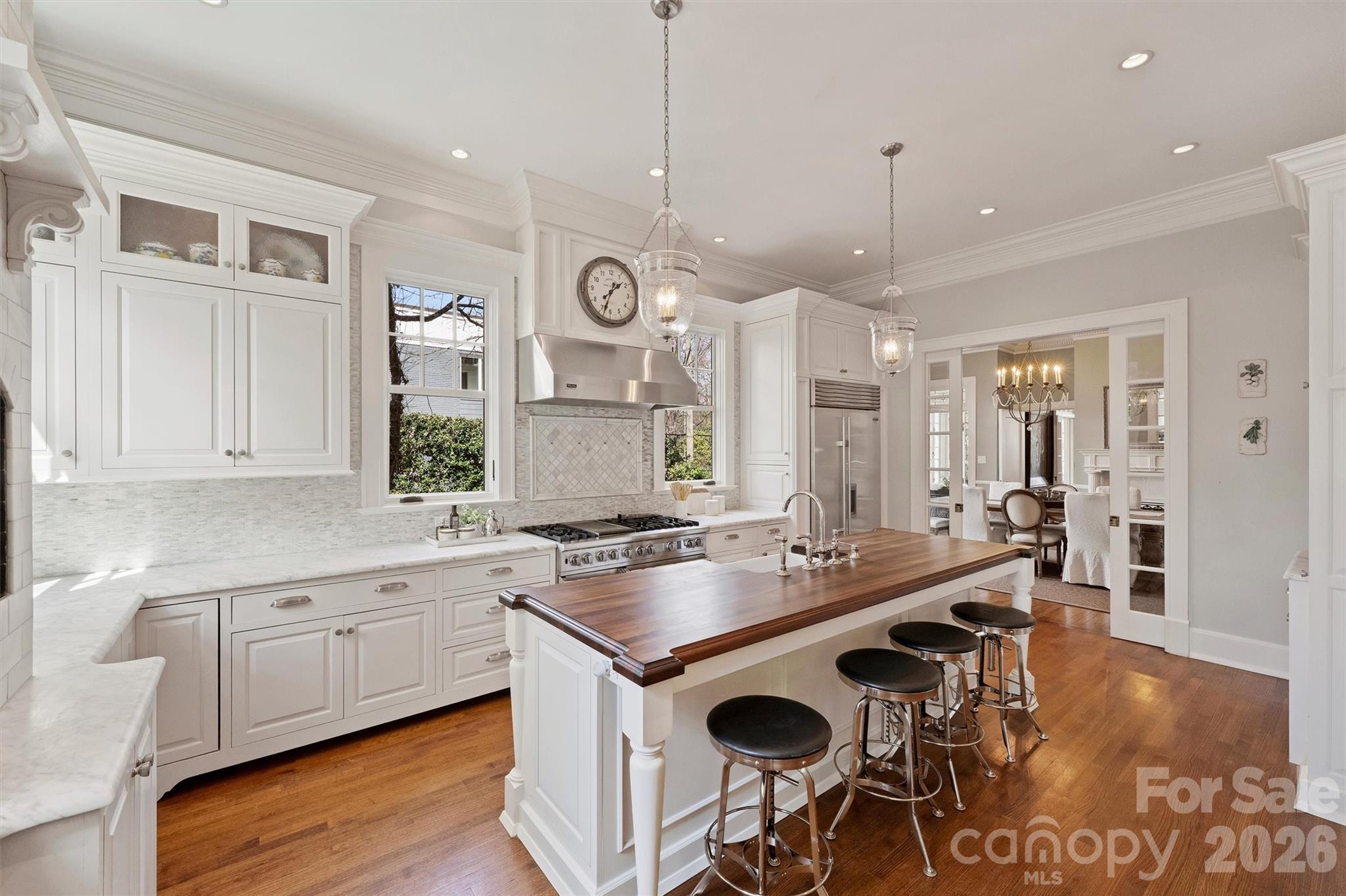 1136 Queens Road Charlotte, NC 28207 - Photo 11 of 43 a kitchen with a stove a sink a dining table and chairs