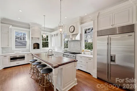 a kitchen with stainless steel appliances granite countertop a stove a refrigerator and a refrigerator