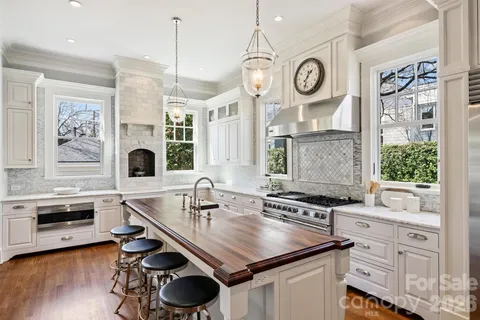 a kitchen with granite countertop a sink a stove and cabinets