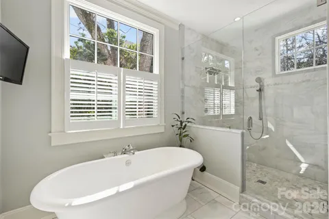 a white bath tub sitting next to a window