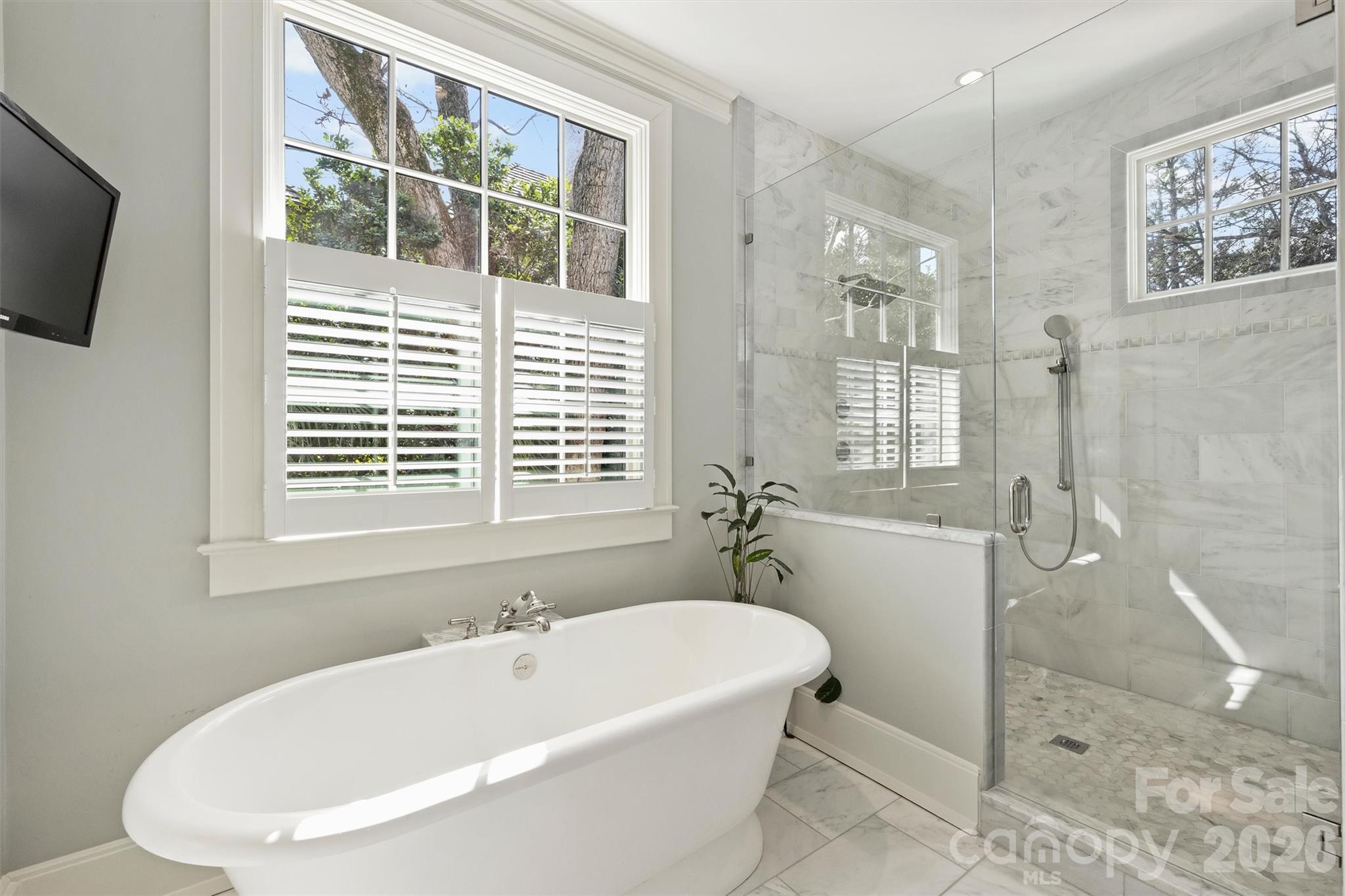 1136 Queens Road Charlotte, NC 28207 - Photo 20 of 43 a white bath tub sitting next to a window