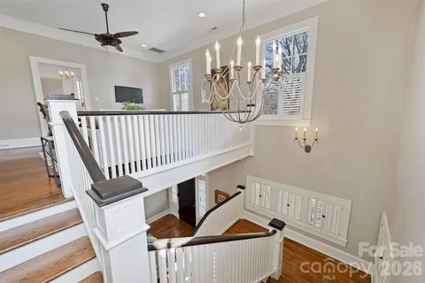 a view of a hallway with entryway and chandelier