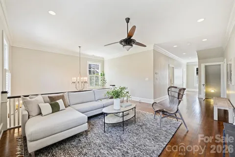a living room with furniture and wooden floor