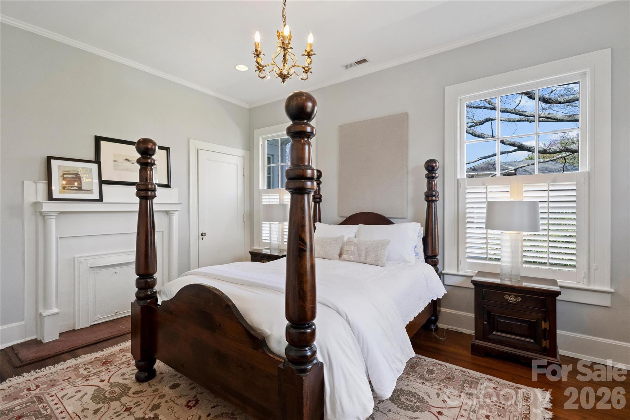 1136 Queens Road Charlotte, NC 28207 - Photo 23 of 43 a bedroom with a bed chandelier and a window