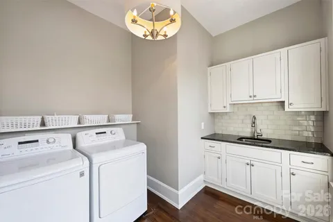 a view of washer and dryer with kitchen countertops