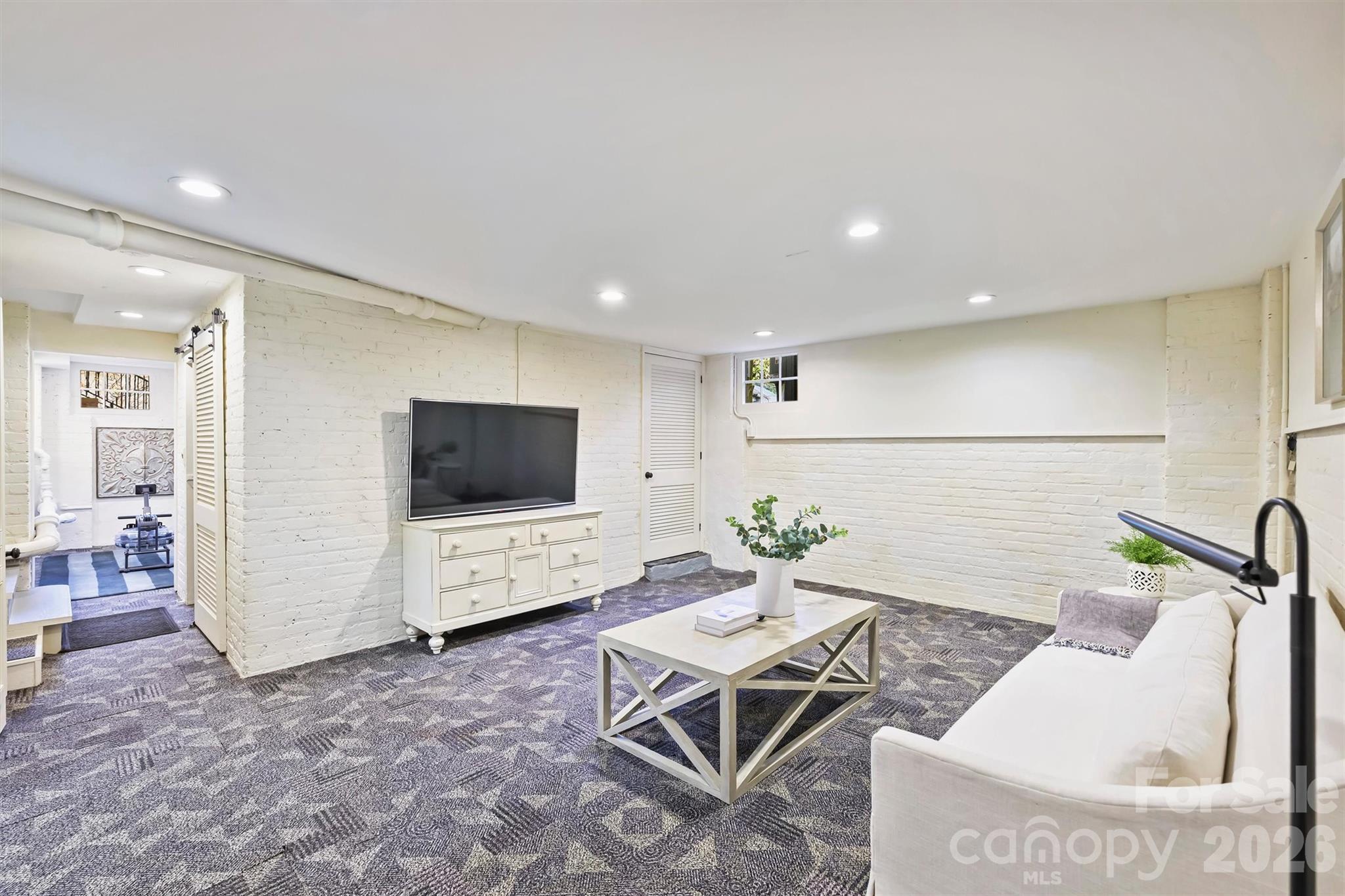 1136 Queens Road Charlotte, NC 28207 - Photo 30 of 43 a living room with furniture and a flat screen tv