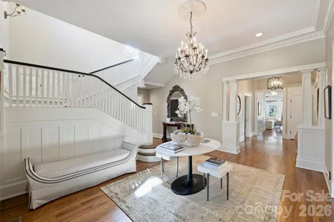 a living room with furniture and a chandelier