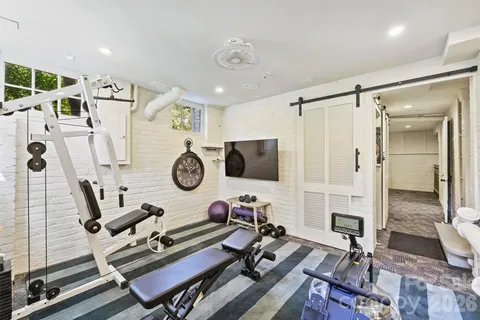 a room with gym equipment and a table