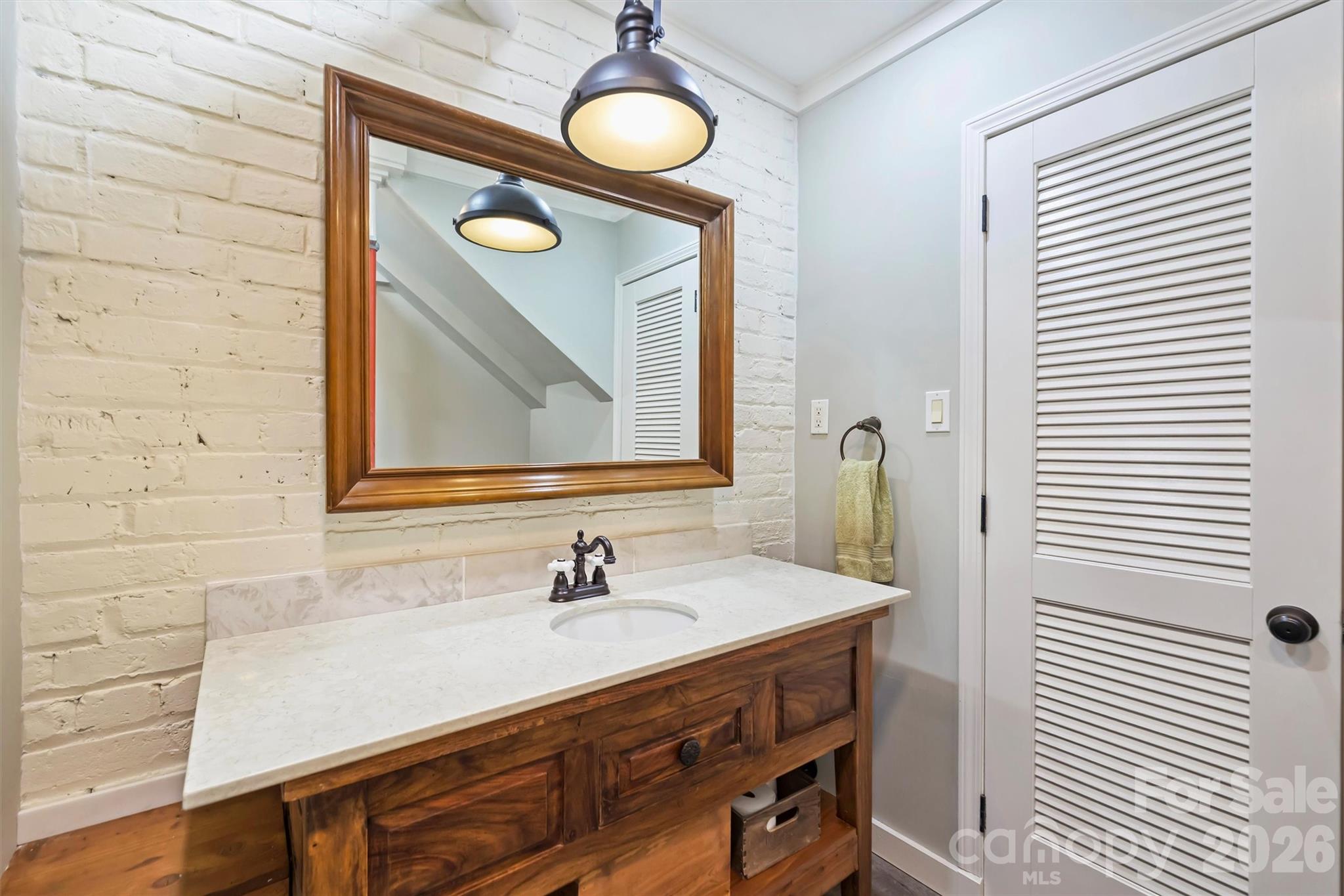1136 Queens Road Charlotte, NC 28207 - Photo 33 of 43 a bathroom with a sink and a mirror