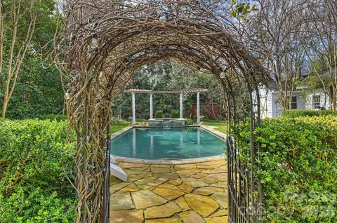 a front view of a house with a yard and fountain