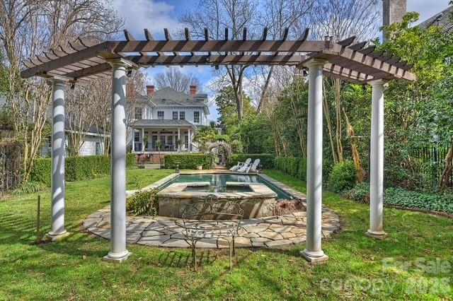 1136 Queens Road Charlotte, NC 28207 - Photo 41 of 43 a view of a patio with table and chairs potted plants and floor to ceiling window