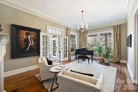a living room with furniture and a chandelier