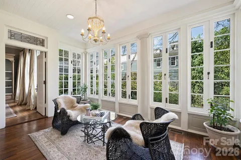 a living room with furniture and a large windows
