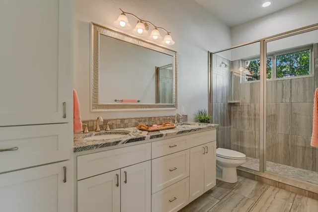 a bedroom with a bed and a ceiling fan