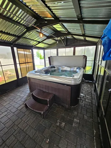 a view of a porch with a table and chairs