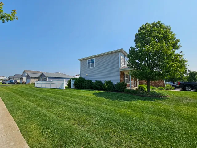 a view of house with wooden deck and furniture