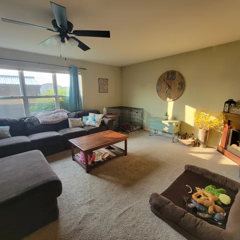 a living room with furniture and a large window