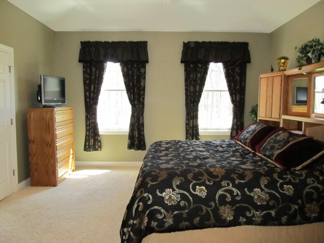 9398 Oak Ridge Drive Rochelle, IL 61068 - Photo 16 of 25 a bedroom with a bed and a mirror
