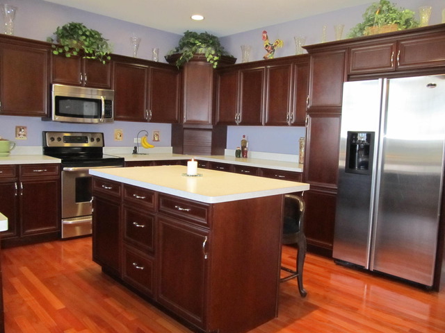 9398 Oak Ridge Drive Rochelle, IL 61068 - Photo 10 of 25 a kitchen with stainless steel appliances granite countertop a refrigerator a stove and a wooden floor