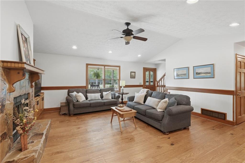 4891 Bill Cheek Road Auburn, GA 30011 - Photo 19 of 99 a living room with furniture and a fireplace