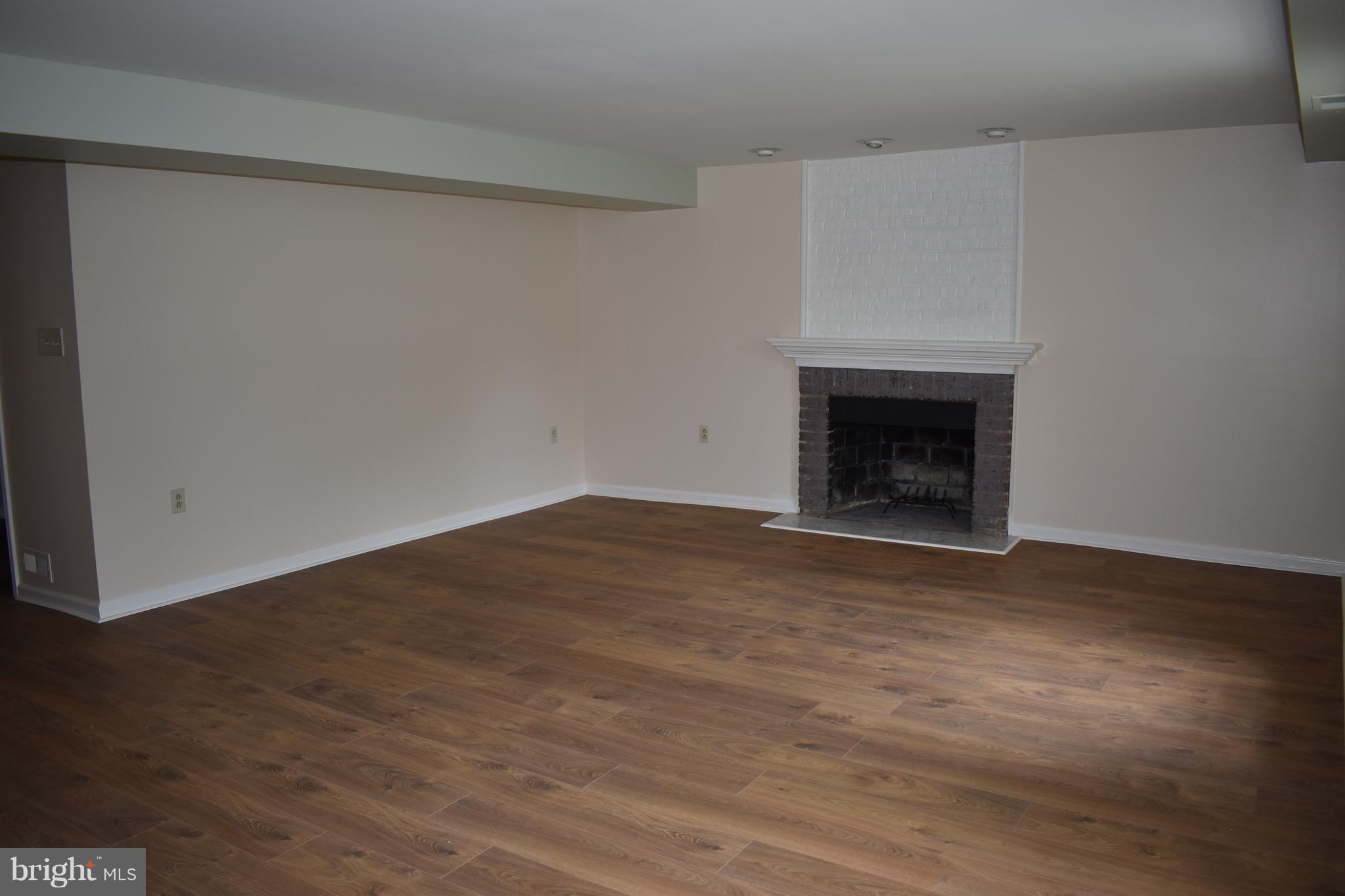 12906 Fletchertown Road Bowie, MD 20720 - Photo 11 of 30 LIVING ROOM WOOD BURNING FIREPLACE