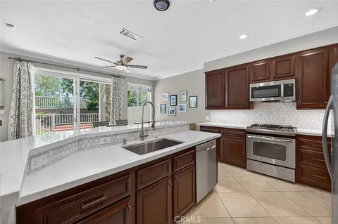 a kitchen with stainless steel appliances granite countertop a sink and a stove