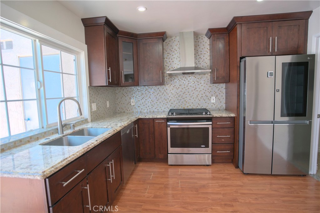 a kitchen with a refrigerator sink and cabinets