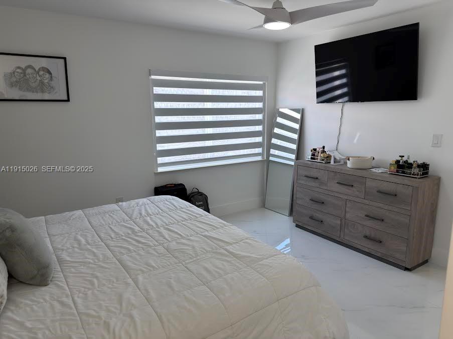 733 Southwest 99th Ct Circle Miami, FL 33174 - Photo 12 of 16 a bedroom with a bed and flat screen tv