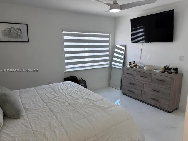 a bedroom with a bed and flat screen tv