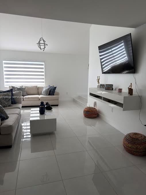 733 Southwest 99th Ct Circle Miami, FL 33174 - Photo 2 of 16 a living room with furniture and a flat screen tv