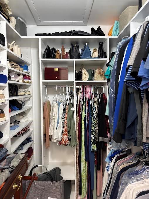 733 Southwest 99th Ct Circle Miami, FL 33174 - Photo 10 of 16 a view of walk in closet with clothes and shoes