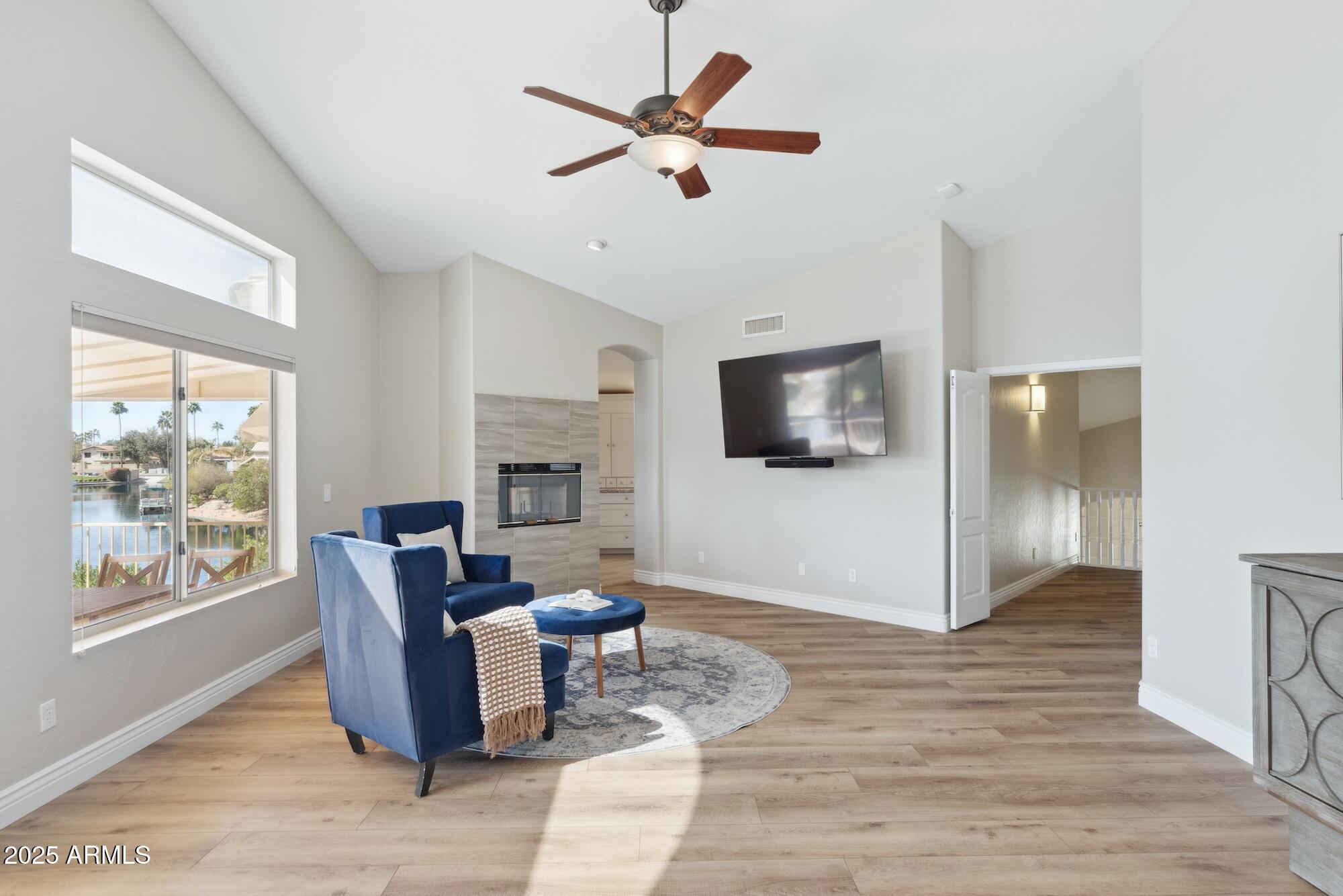1321 West Shellfish Drive Gilbert, AZ 85233 - Photo 13 of 65 a living room with furniture a flat screen tv and a floor to ceiling window