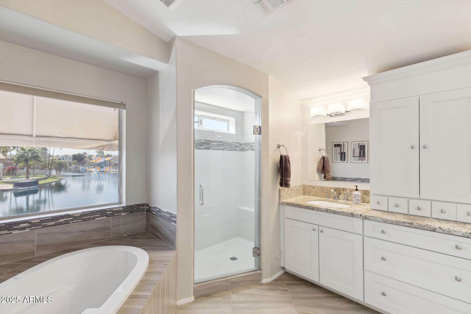 1321 West Shellfish Drive Gilbert, AZ 85233 - Photo 16 of 65 a bathroom with a granite countertop sink mirror and bathtub