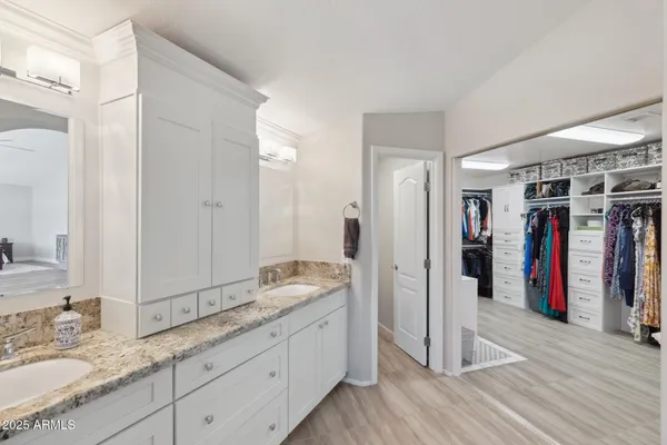 a kitchen with stainless steel appliances kitchen island granite countertop a stove and white cabinets