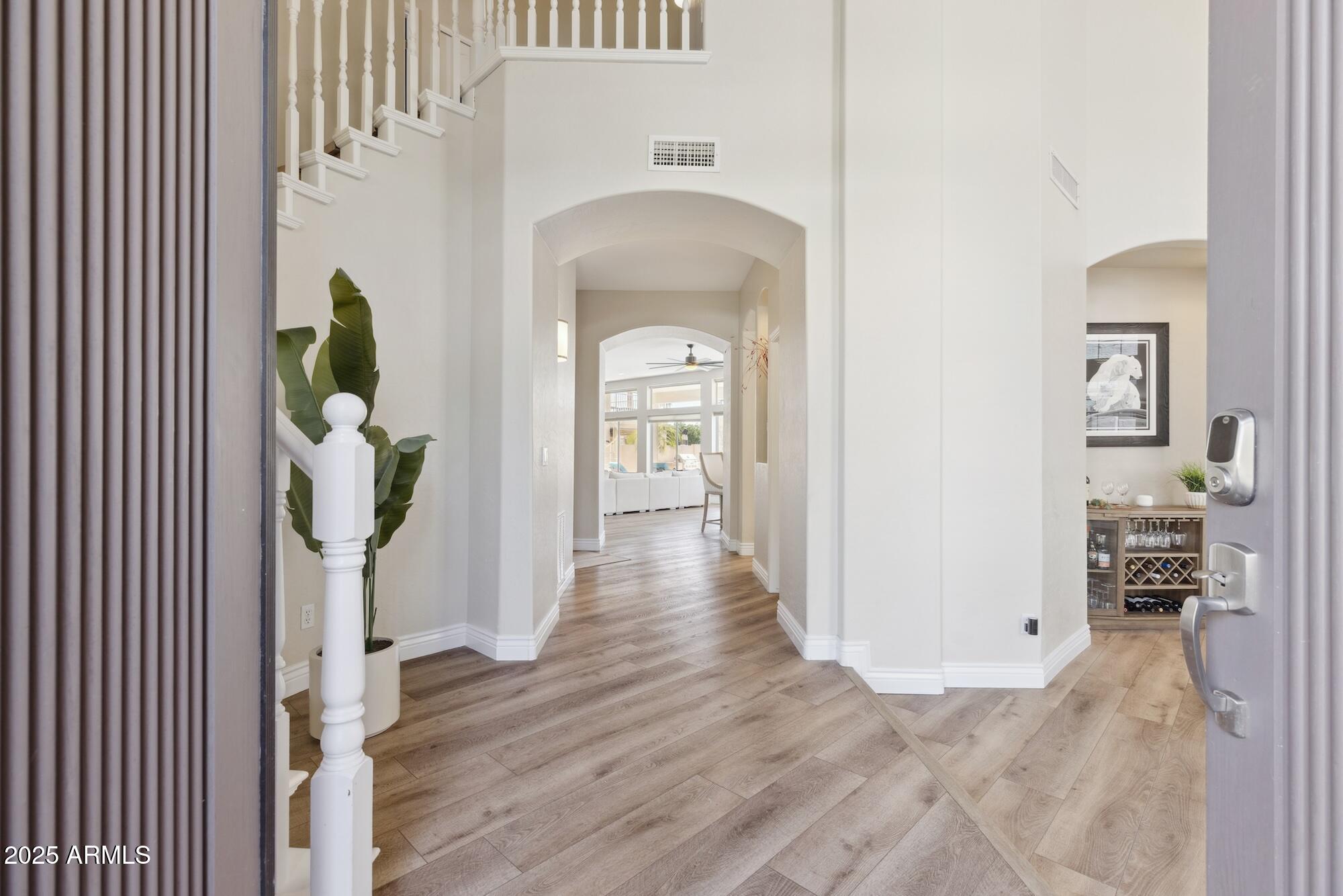 1321 West Shellfish Drive Gilbert, AZ 85233 - Photo 30 of 65 a view of a hallway with wooden floor windows and livingroom