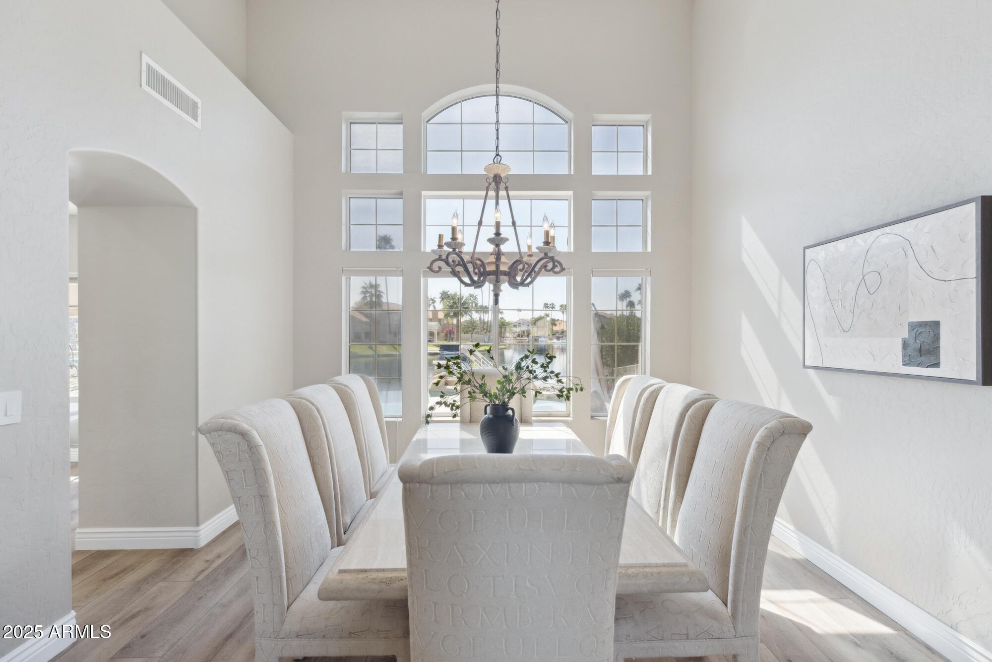1321 West Shellfish Drive Gilbert, AZ 85233 - Photo 33 of 65 a view of a dining room with furniture a chandelier and wooden floor