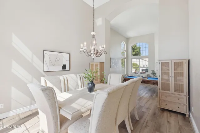a large white kitchen with a large window appliances and cabinets