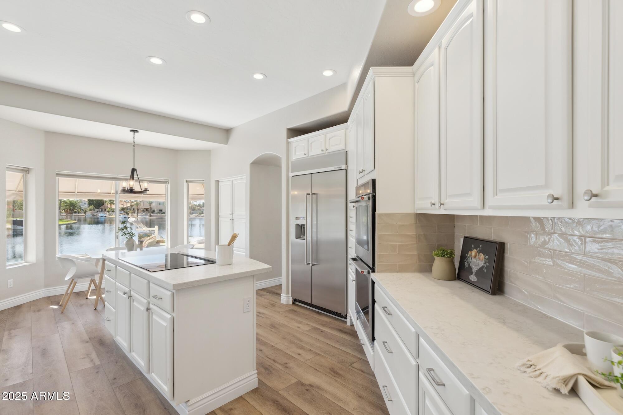 1321 West Shellfish Drive Gilbert, AZ 85233 - Photo 40 of 65 a kitchen with stainless steel appliances granite countertop a sink stove and refrigerator