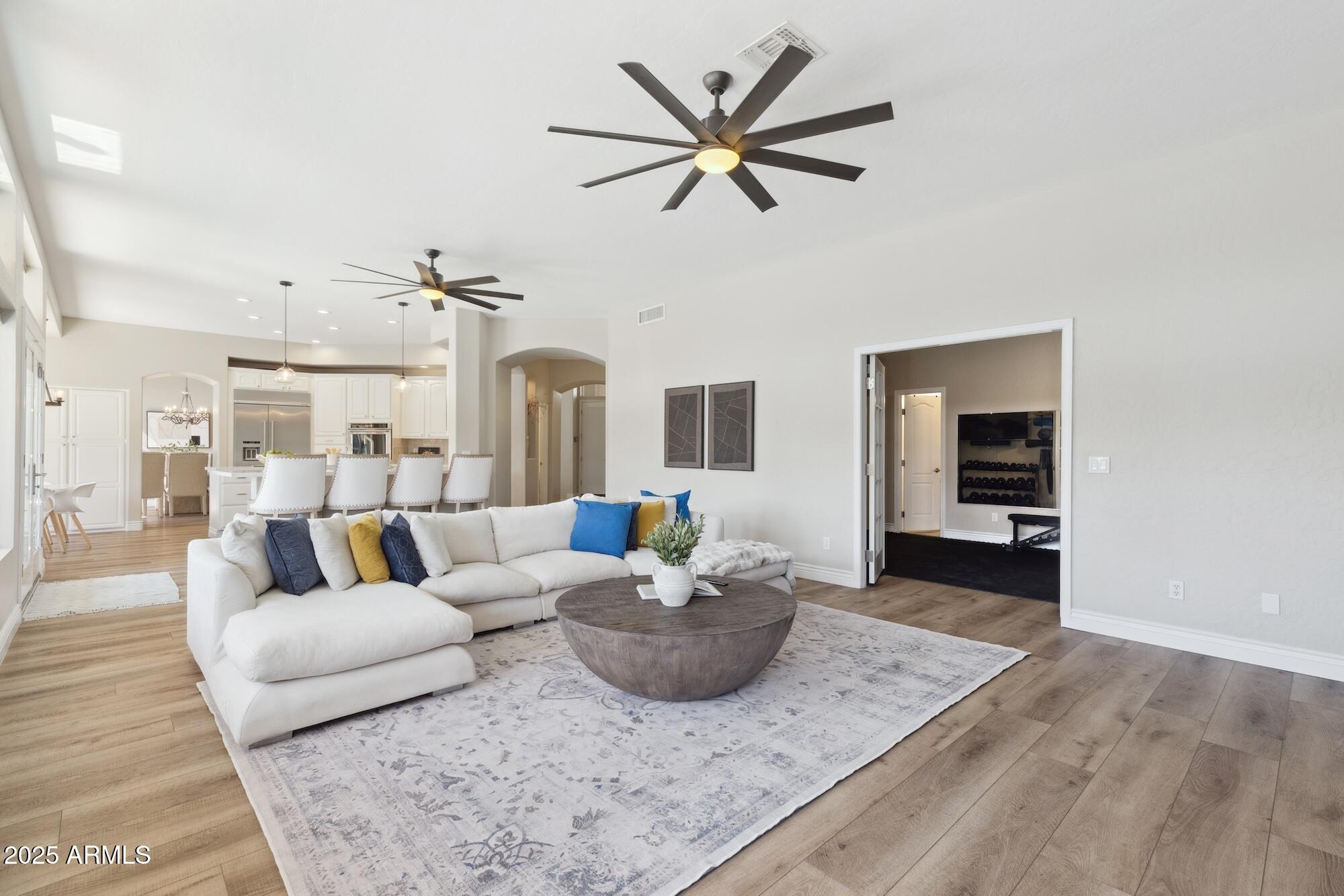 1321 West Shellfish Drive Gilbert, AZ 85233 - Photo 46 of 65 a living room with furniture and a wooden floor