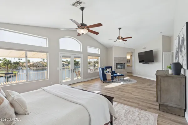 a bedroom with a large bed and a large window