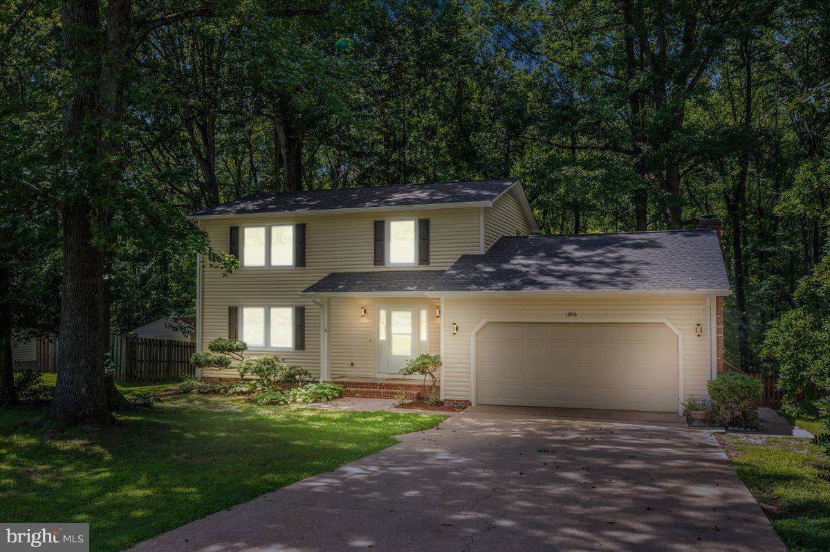 11816 Rutherford Drive Fredericksburg, VA 22407 - Photo 1 of 64 a front view of a house with a garden and yard