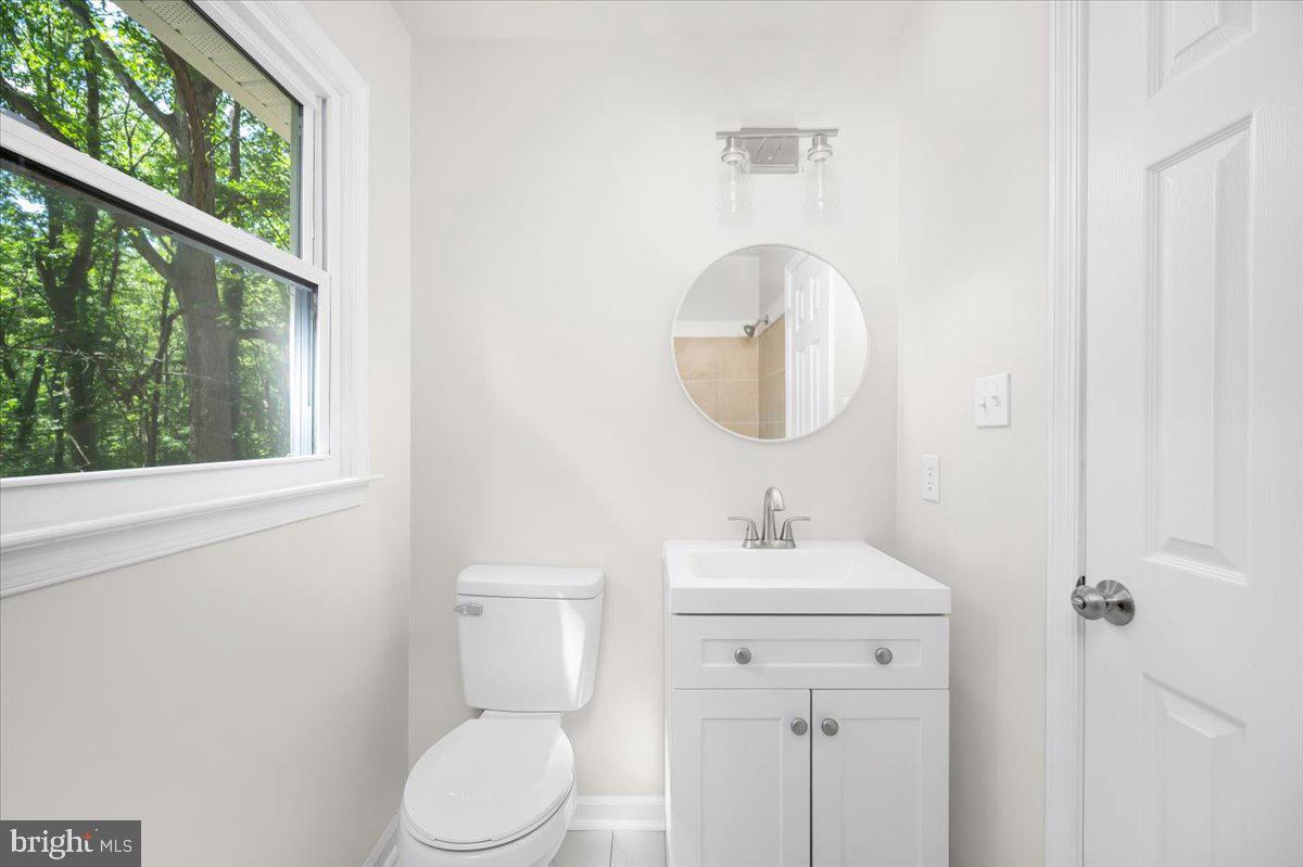 11816 Rutherford Drive Fredericksburg, VA 22407 - Photo 23 of 64 a bathroom with a toilet a sink and a mirror