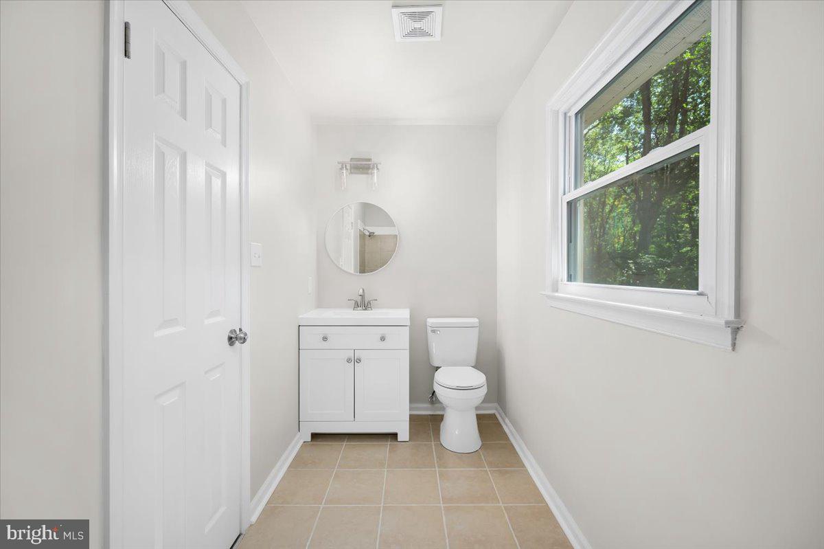 11816 Rutherford Drive Fredericksburg, VA 22407 - Photo 28 of 64 a bathroom with a toilet a sink and a window