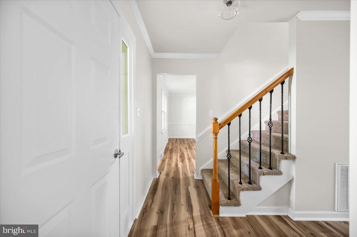 11816 Rutherford Drive Fredericksburg, VA 22407 - Photo 32 of 64 a view of a hallway with wooden floor and staircase