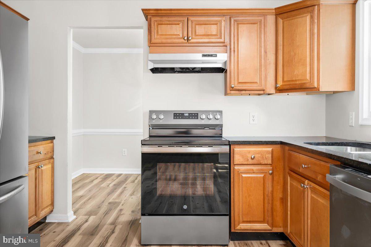 11816 Rutherford Drive Fredericksburg, VA 22407 - Photo 46 of 64 a kitchen with granite countertop a stove and a sink