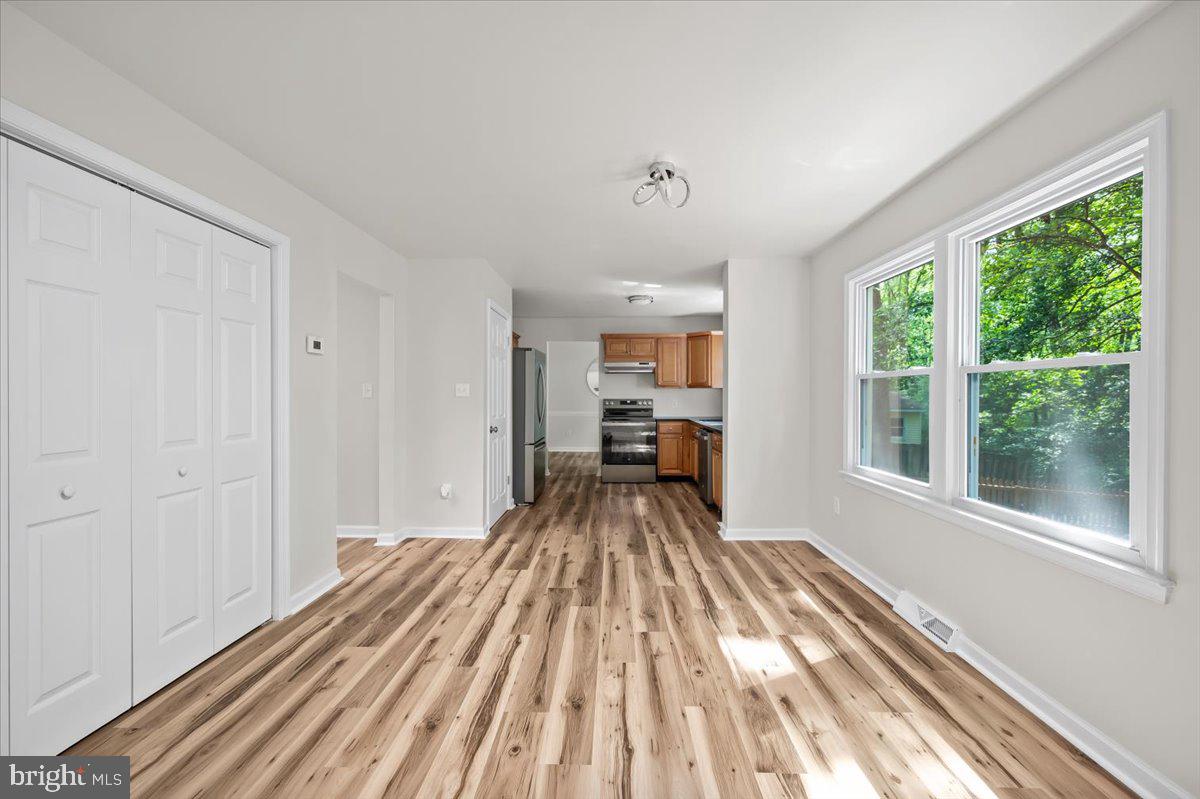 11816 Rutherford Drive Fredericksburg, VA 22407 - Photo 50 of 64 a view of a bedroom with a bed and wooden floor