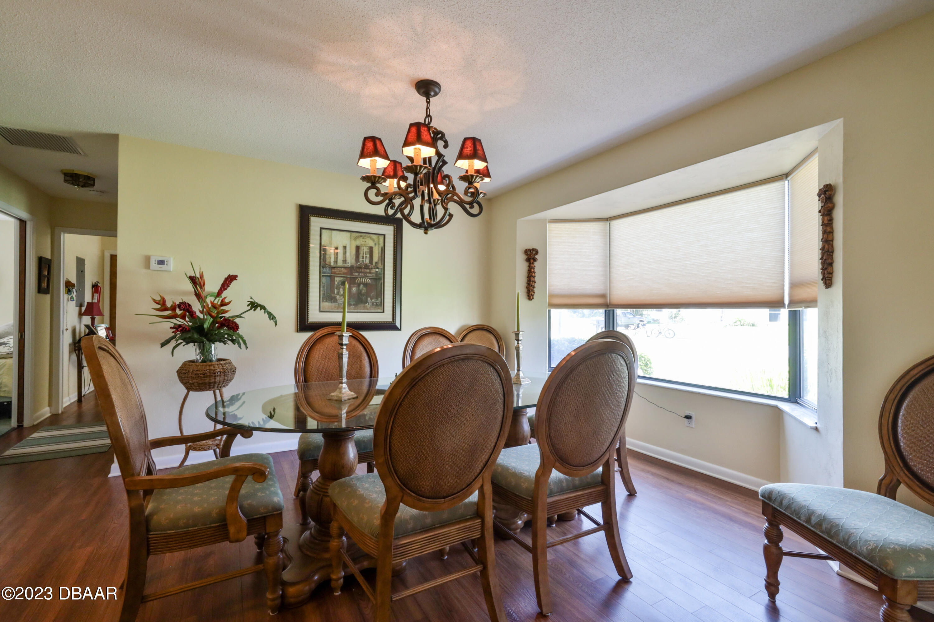 118 Sand Dunes Drive Ormond Beach, FL 32176 - Photo 12 of 46 a dining room with furniture a potted plant and wooden floor