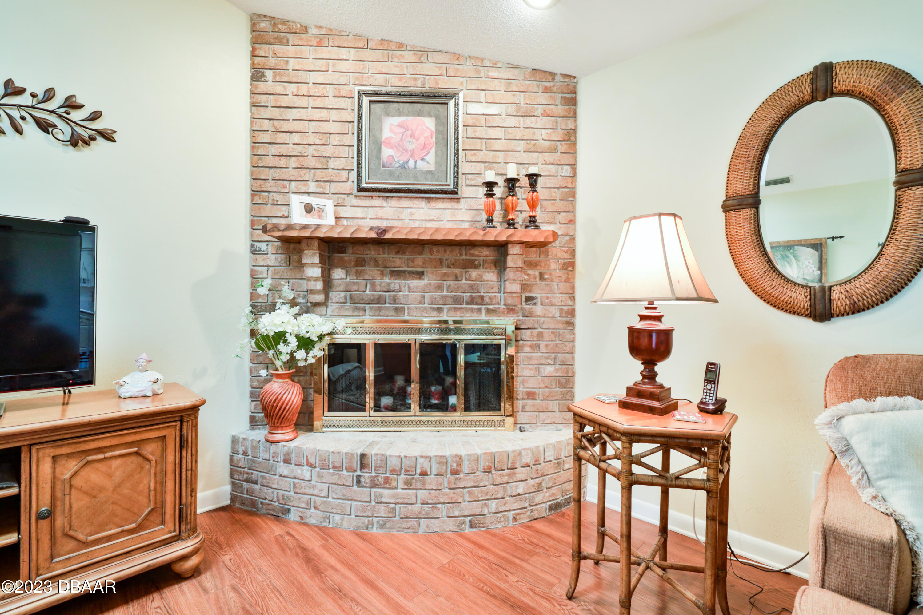 118 Sand Dunes Drive Ormond Beach, FL 32176 - Photo 16 of 46 a living room with furniture a flat screen tv and a fireplace